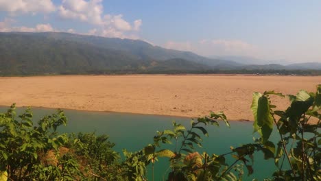 vast mountain valley with sandy dessert and clouds