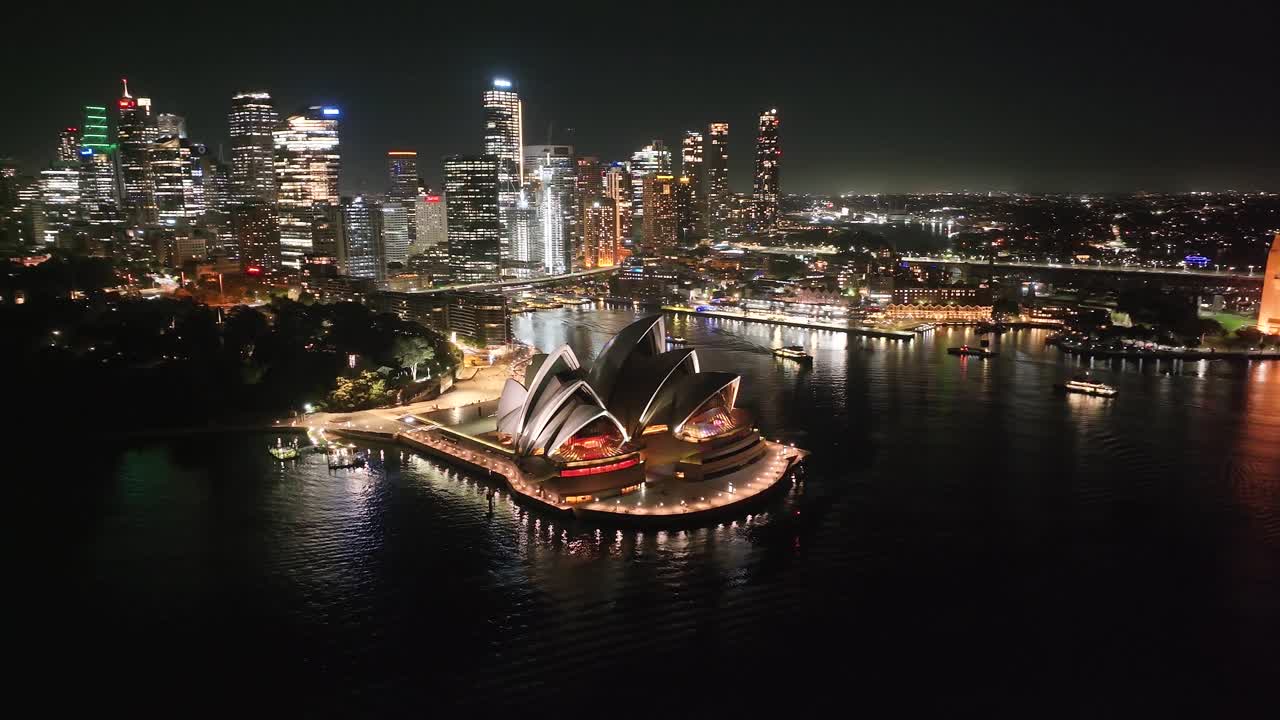 Beautiful aerial at night. Sydney Opera House building, Harbour Bridge and city lights in CBD
