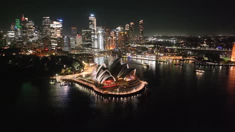 beautiful aerial at night. sydney opera house building, harbour bridge and city lights in cbd