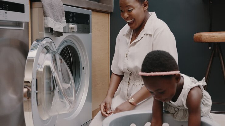 Mother, child and laundry with high five