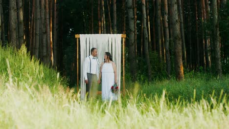 couple kissing at rustic outdoor wedding ceremony