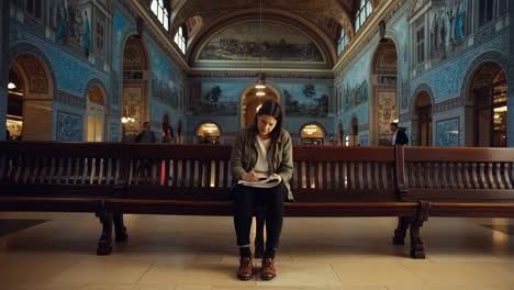 woman reading a book on a bench