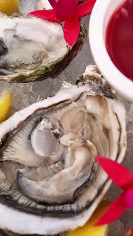 fresh oysters with red sauce and lemon