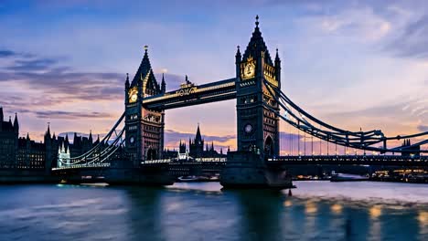 tower bridge is changing colors during a beautiful sunset with the palace of westminster in the background