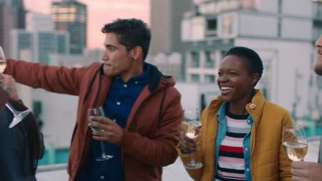 cheerful group of friends enjoying rooftop party celebration drinking alcohol making toast having fun social gathering celebrating weekend of friendship at sunset