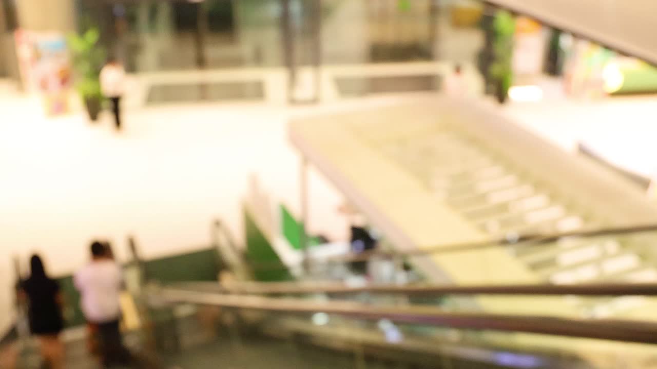 바쁜 쇼핑몰 에서 에스컬레이터 를 사용 하는 사람 들