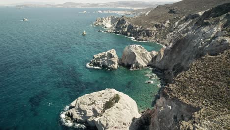 slowly moving past a rocky cliffside overlooking the breathtaking turquoise blue water of the mediterranean