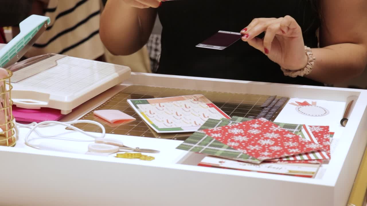 Gluing scrapbooking art for Christmas themed gift cards, paper crafts
