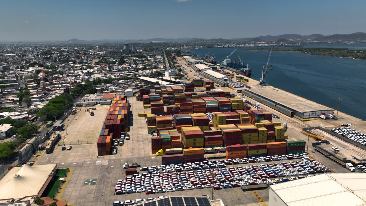 Aerial view of a busy port with containers, vehicles, and ships