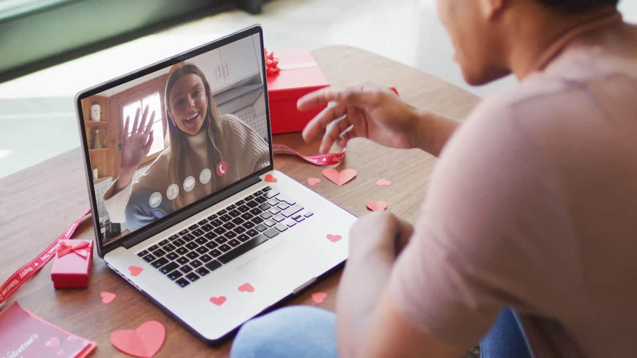 Happy caucasian woman waving and making valentine's day video call on laptop