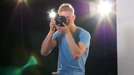 male photographer photographing with digital camera