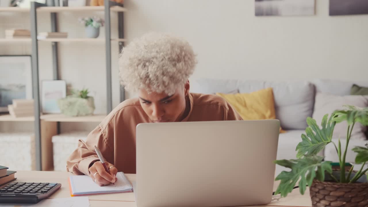 African woman calculating utility bills managing monthly budget finances
