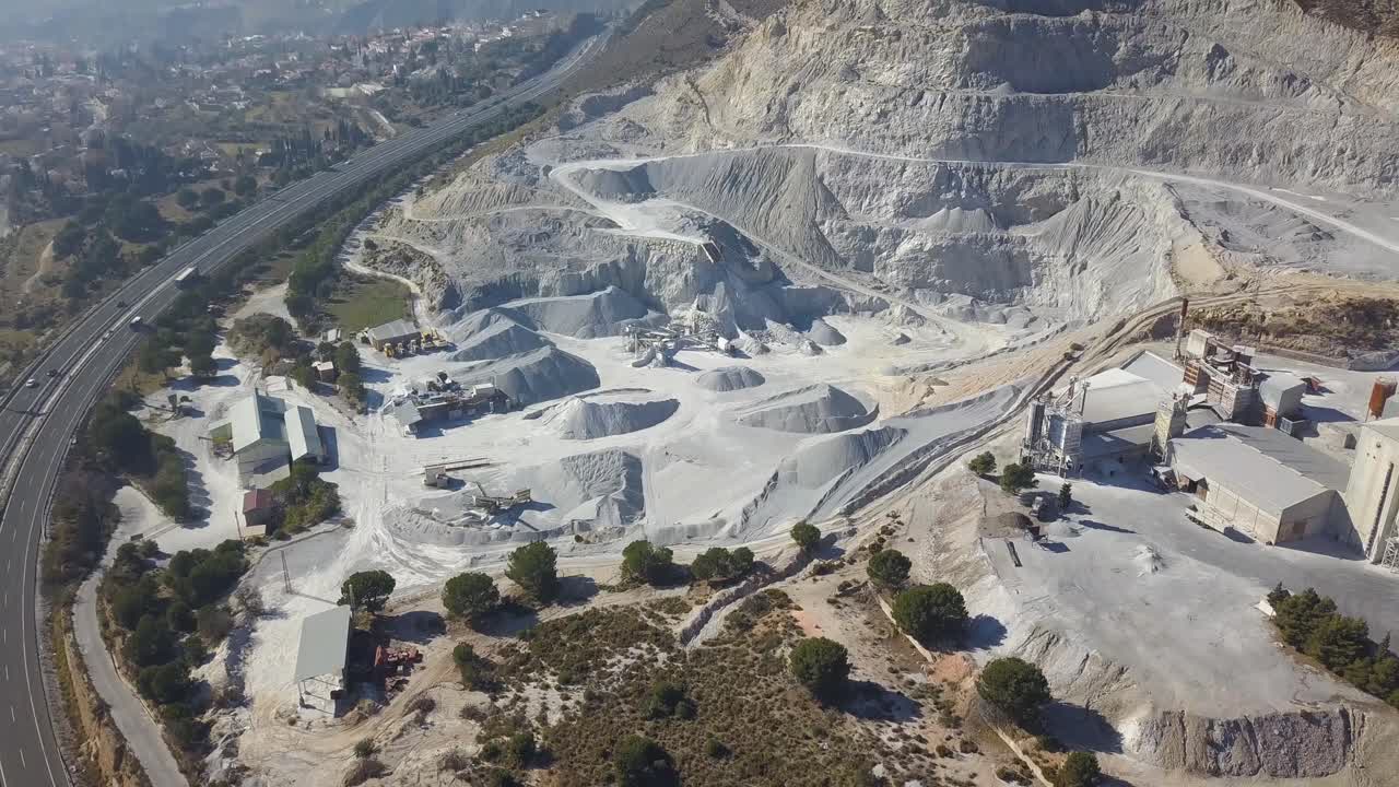 Aerial revealing view of a big quarry in a mountain