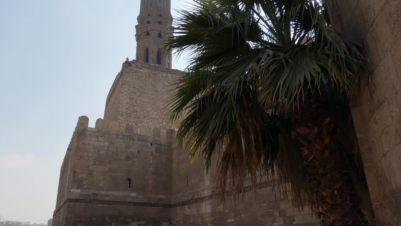 las paredes exteriores y el minarete de la mezquita masjid al-hakim, el cairo islámico, egipto.