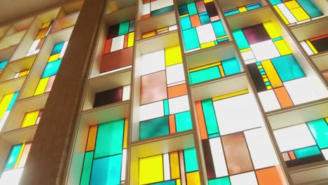 wide dolly shot of a gorgeous stained glass window wall blossoming with vibrant colors