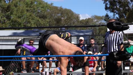 wrestler performs acrobatic flip on opponent