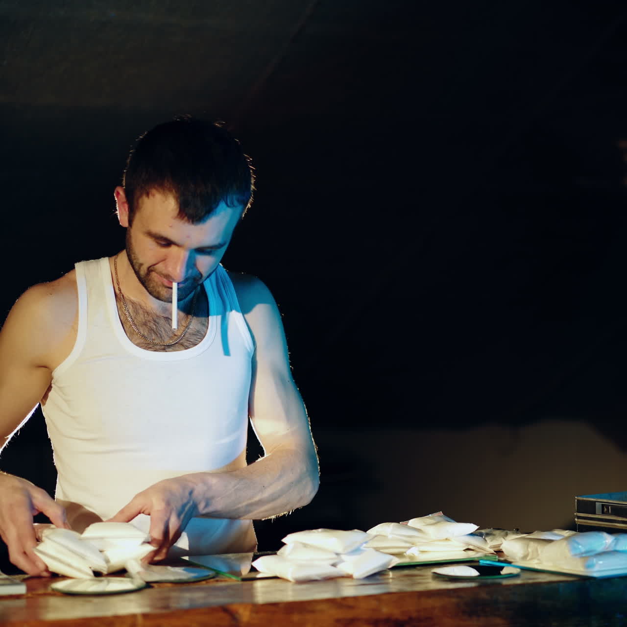 Gun, drugs and money. Drug dealer stacks the heroin filled bags in a suitcase Square video