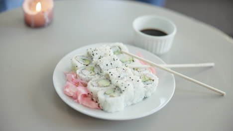 Sushi,-food-and-plate-closeup-of-chopstick-at-home