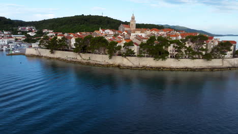 korcula old town from adriatic sea in korcula island, croatia. - aerial tilt up shot