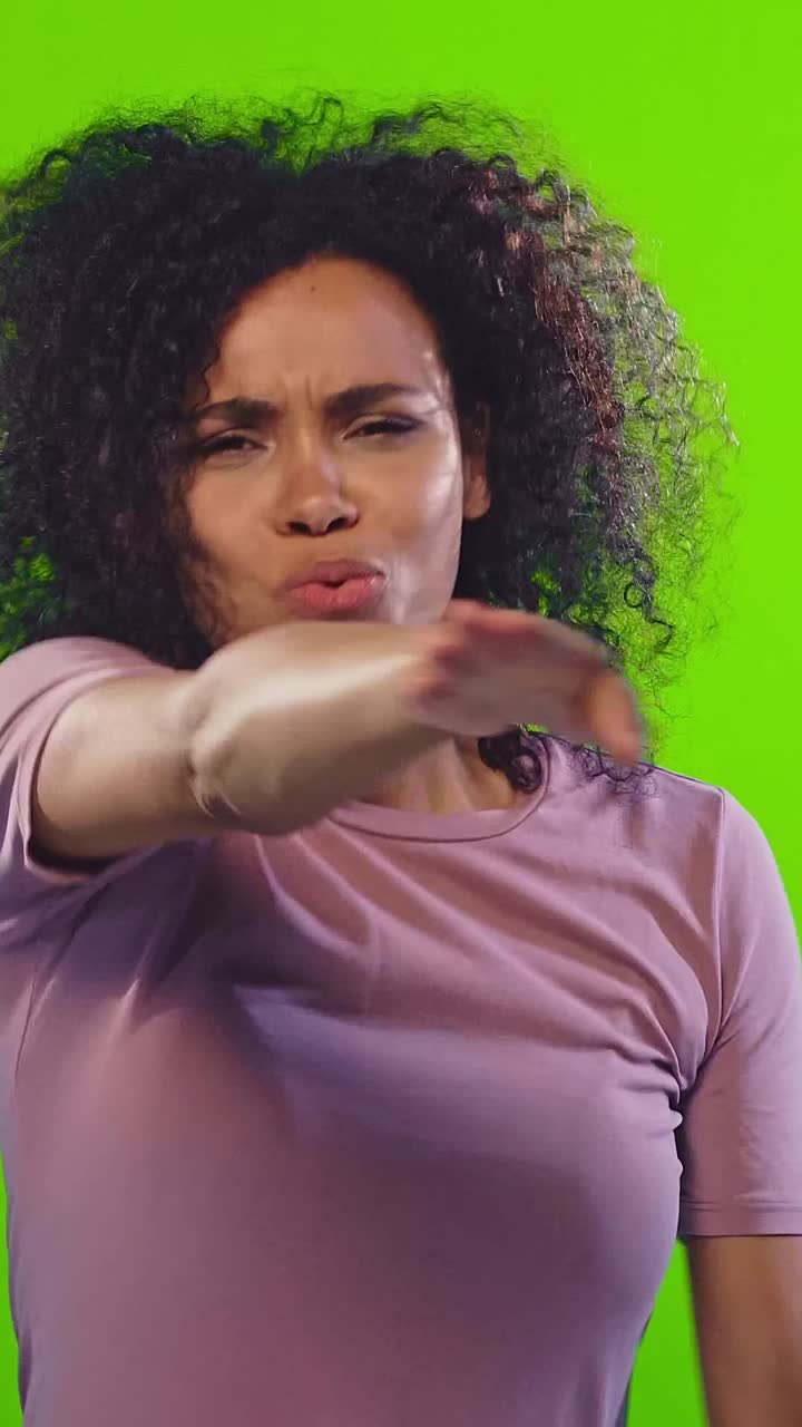 Emotional reaction while talking on the phone against a green background