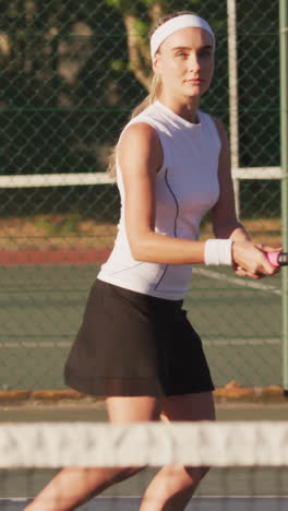 video of focused caucasian female tennis player holding racket and hitting ball