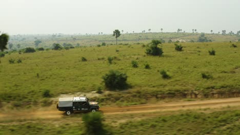 animal ambulance in africa speeds along dirt road to rescue an animal for conservation