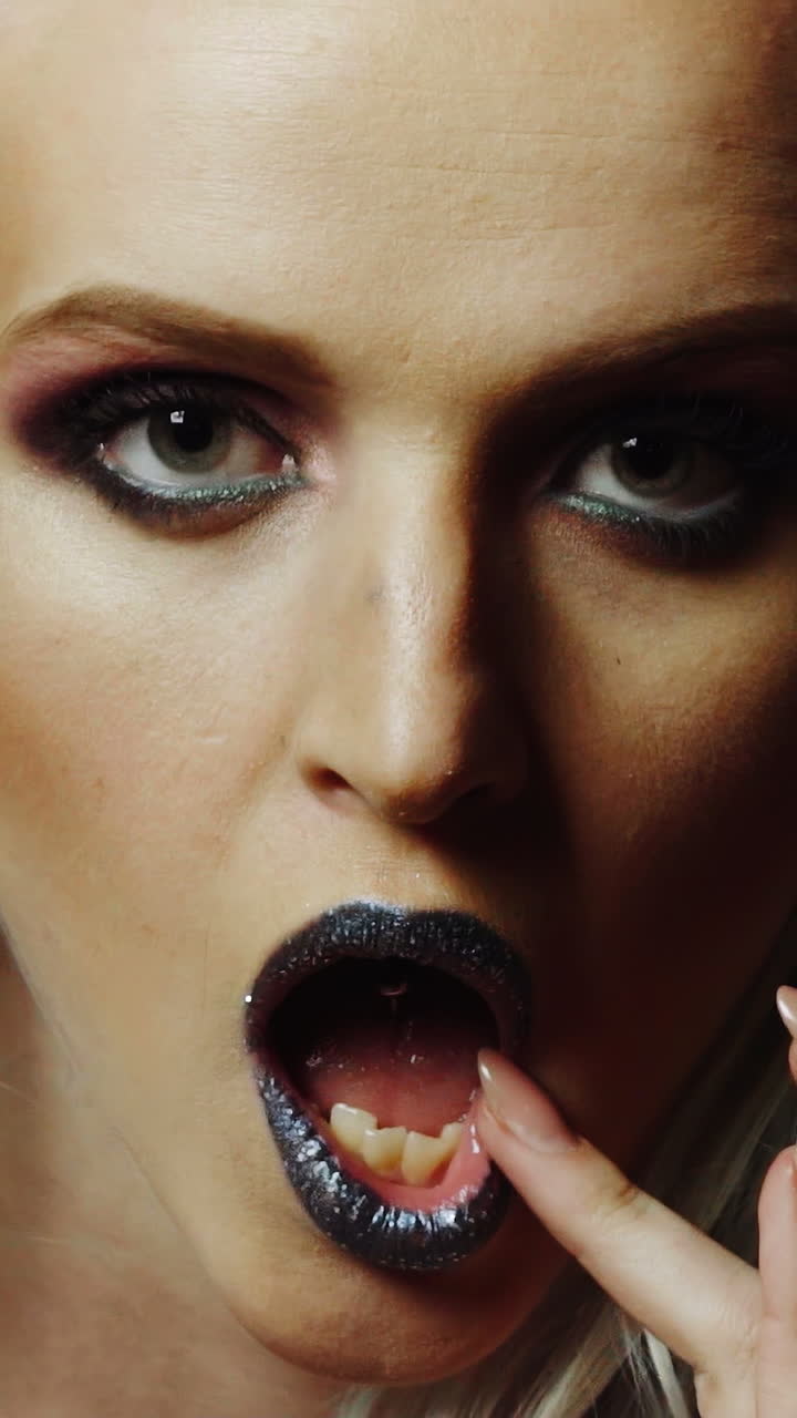 Colourful Studio Shot of Funny Model Girl. Beauty woman portrait with colorful makeup and hair