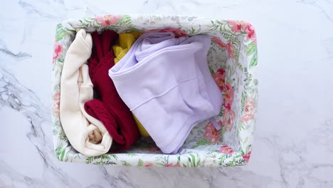 folding clothes in a basket