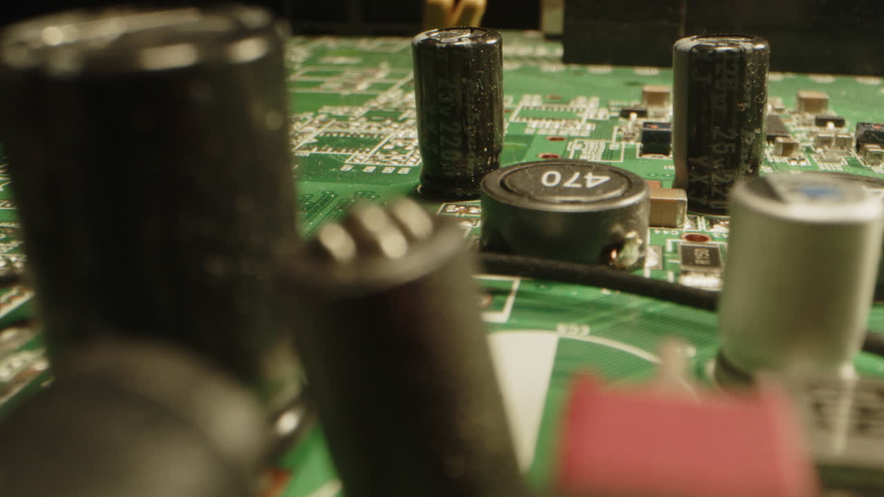 Stunning macro dolly of a circuit board witch visible components as capacitors, transistors and diodes
