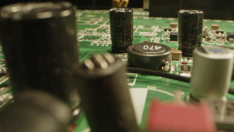 stunning macro dolly of a circuit board witch visible components as capacitors, transistors and diodes
