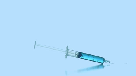 animation of red dots over falling syringe with blue reagent