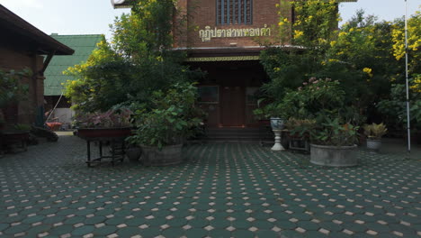 Wat Chet Lin Temple Surrounded By Lush Greenery In Chiang Mai, Thailand. dolly-out, tilt-down shot