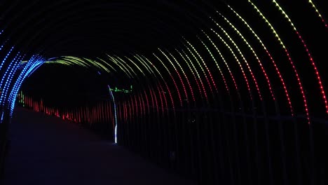 led lighting festival in the park walking through led tunnel - slow mo