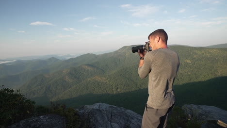 photographer mountain view taking photo overlook sunrise hike