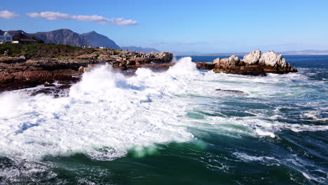 atlantic ocean waves smash into rugged hermanus shoreline