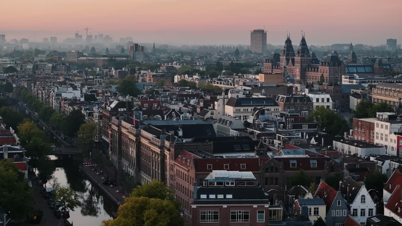Amsterdam wakes at sunrise with fog, reflections, and the Rijksmuseum