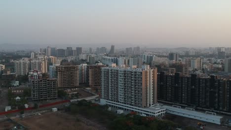 Aerial-footage-shot-in-a-growing-Indian-city-showcasing-architectural-buildings-as-well-as-new-residential-apartments