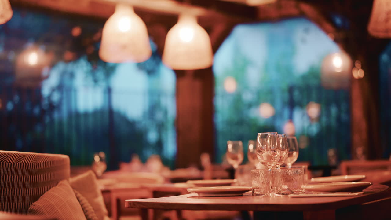 Woman with long wavy hair, viewed from behind as she looks at pastries through the display glass