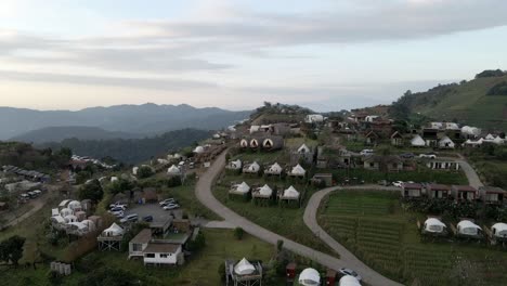 Reveal-shot-of-the-sunrise-in-the-mountain-above-the-village-for-camping