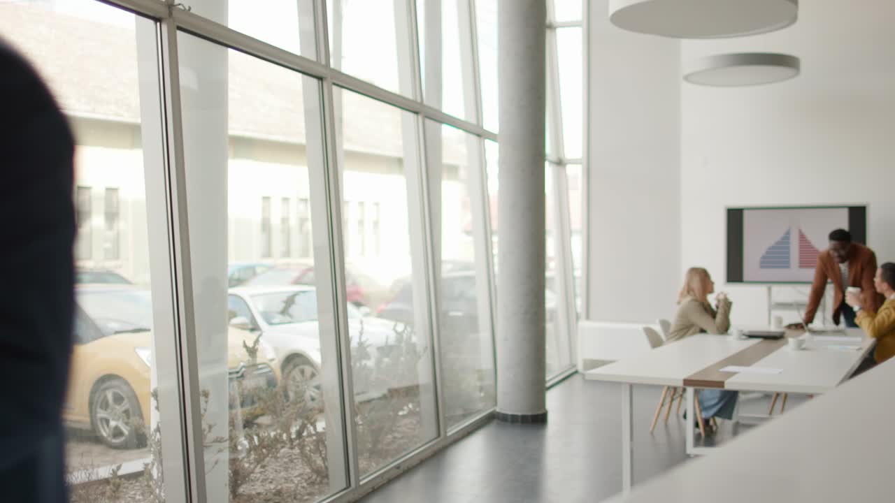 jóvenes empresarios caminando juntos y usando tableta digital en la oficina moderna