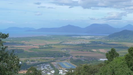 view of vast landscape in mist with mountains in background in cairns region, qld, australia