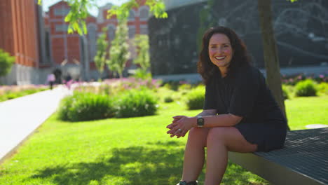 woman sitting in a park on a bench wearing roller skates