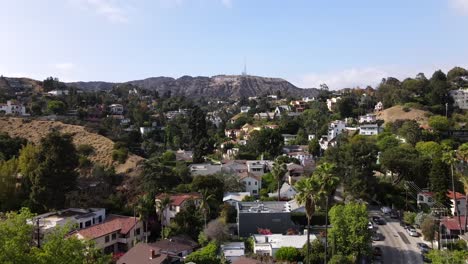 rising over hollywood neighborhood, famous hollywood sign, clear day