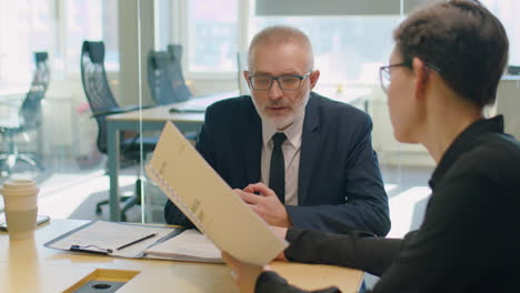 colleagues discussing financial report in office