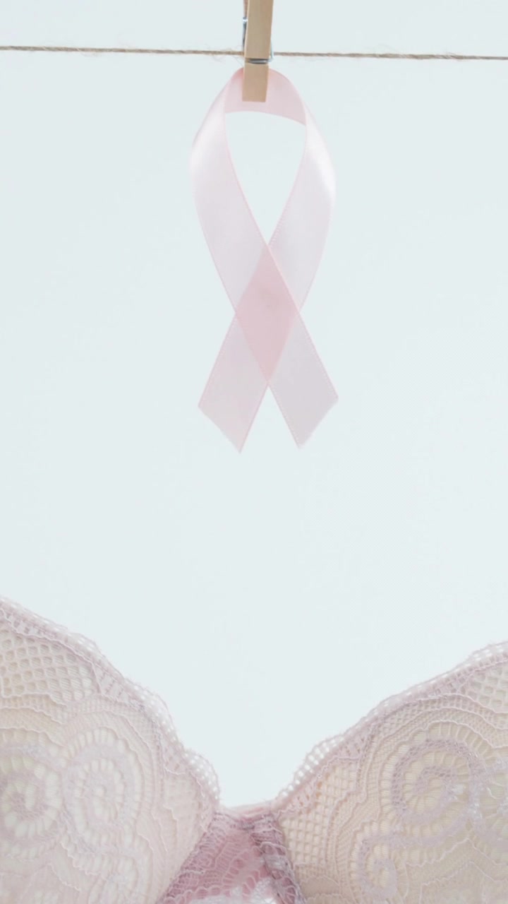 Animation of bra and ribbon hanging on wire on white background ...