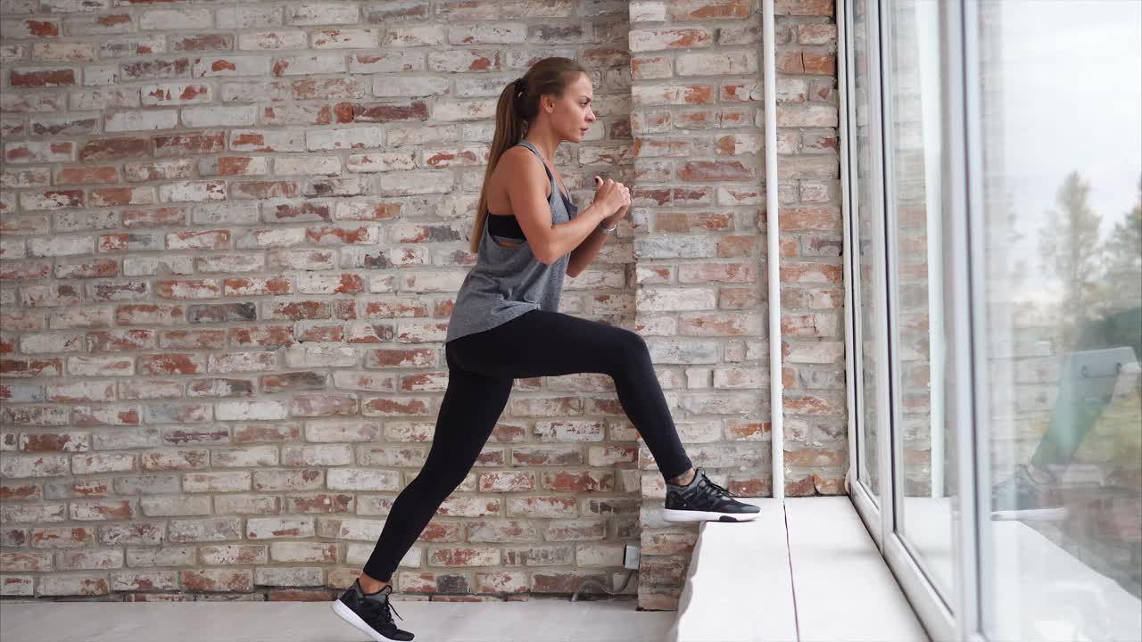 Woman doing lunges near a window