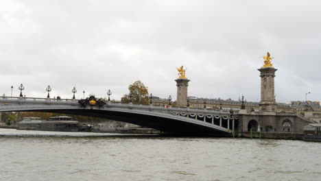 gilded fames sculptures on socle counterweights of pont alexandre iii, paris