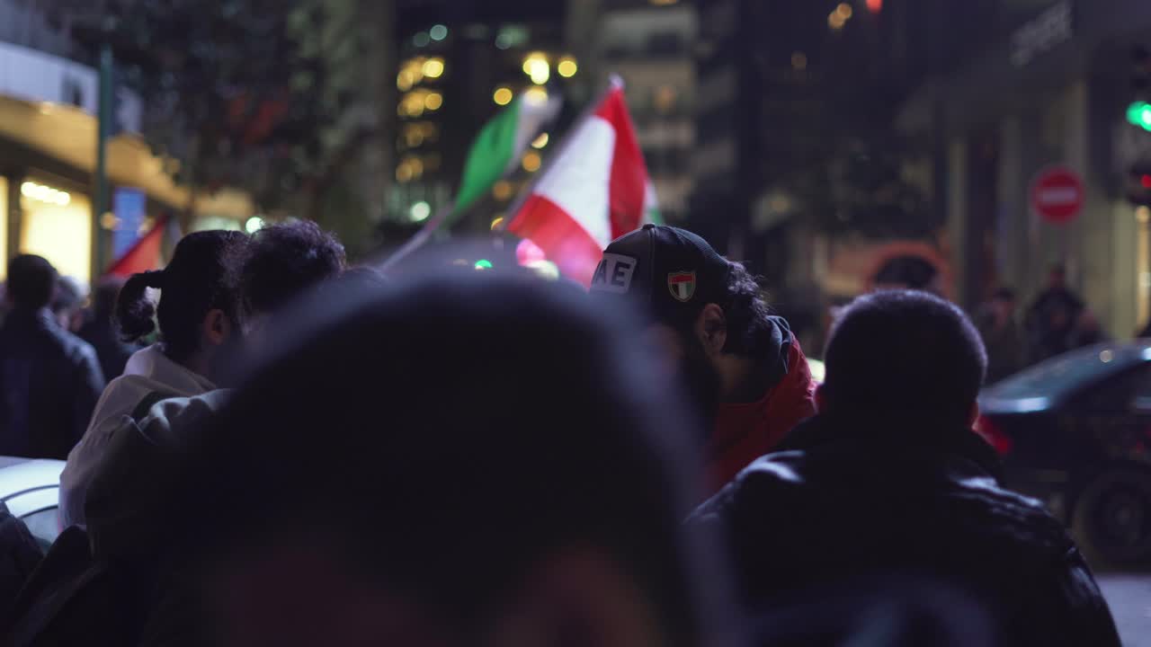 Lebanese protesters gather in the street to talk and smoke a cigarette