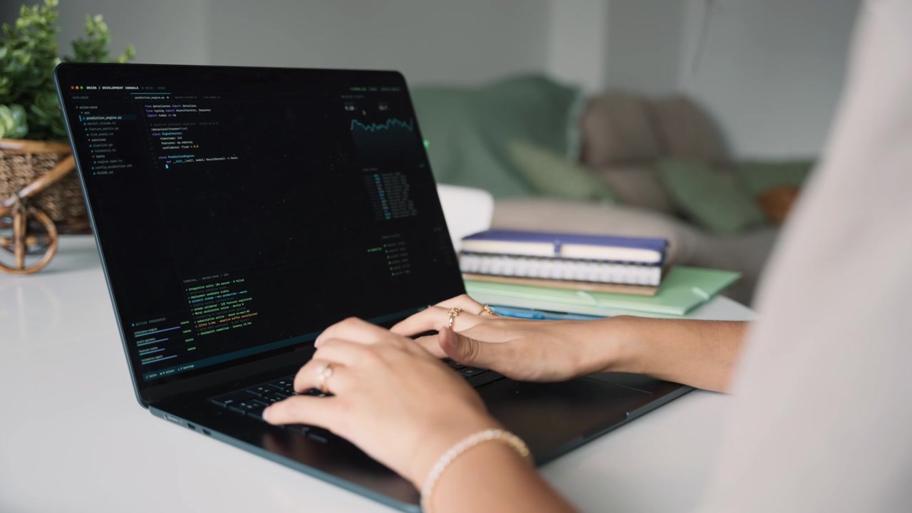 Software Developer Writing Code on Laptop in Home Office
