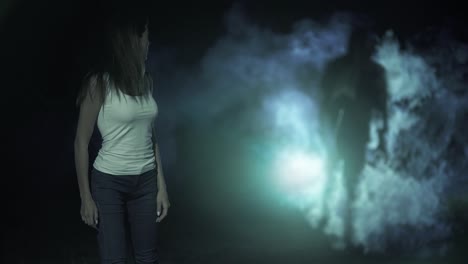 the female walking in a dark park against a man in a smoke behind. slow motion